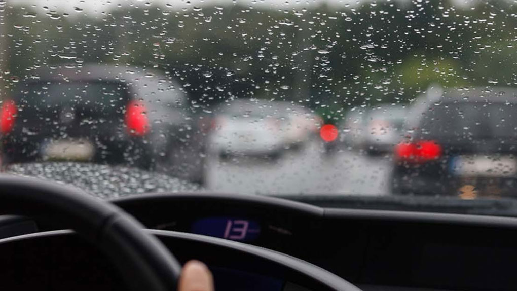 car driving safely on wet road in Dubai low visibility conditions